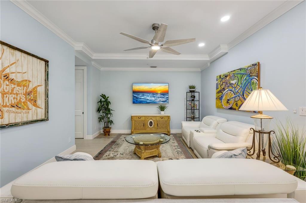 269 Colonade Circle, Unit 2802 Naples, FL 34103 - Photo 9 of 50 a living room with furniture and a flat screen tv