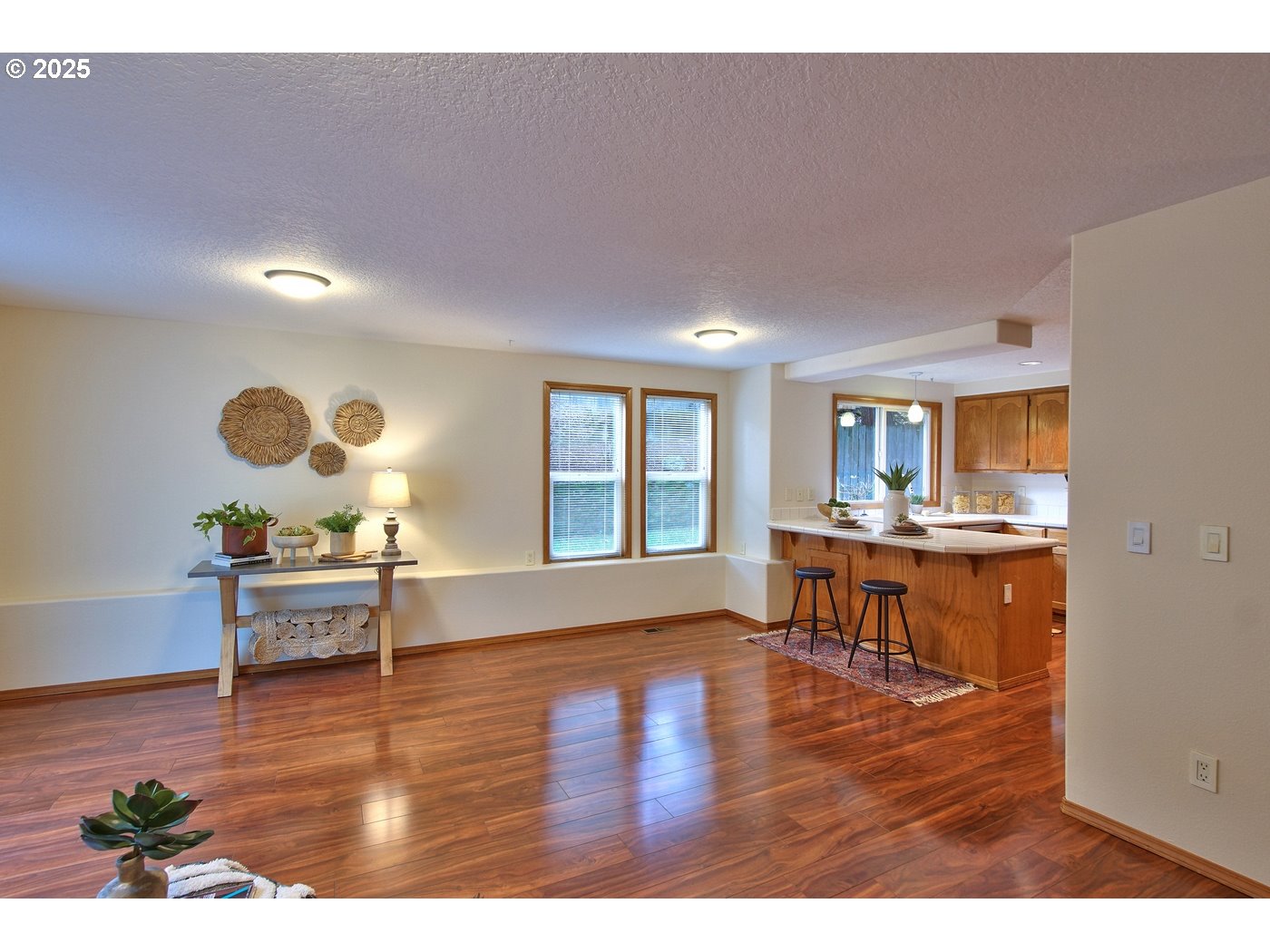 8411 Southwest 184th Loop Beaverton, OR 97007 - Photo 12 of 34 a living room with kitchen view and a wooden floor