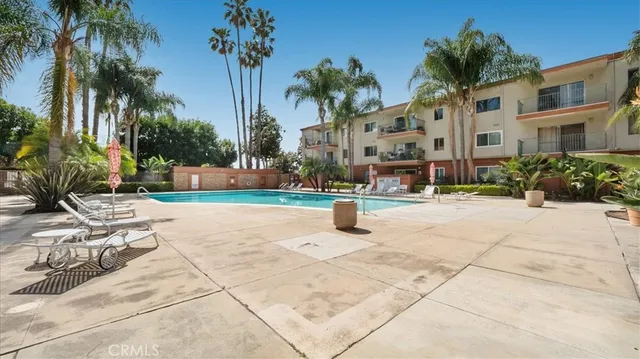 a view of multiple house with palm trees