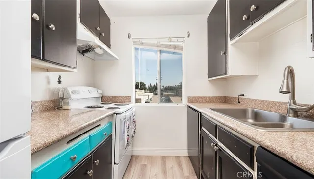 a kitchen with a sink stove and cabinets