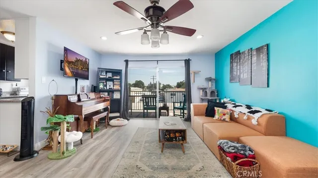 a living room with furniture and wooden floor