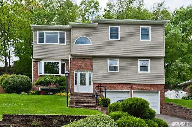 12 Underhill Road Glen Head, NY 11545 - Photo 1 of 1 a front view of a house with a garden