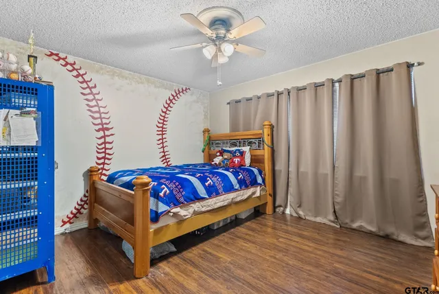a view of a room with wooden floor and cabinet