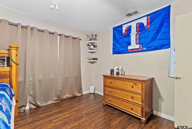 a bed room with a bed and a chair