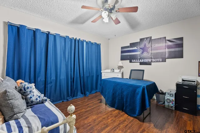 a bedroom with furniture and a book shelf