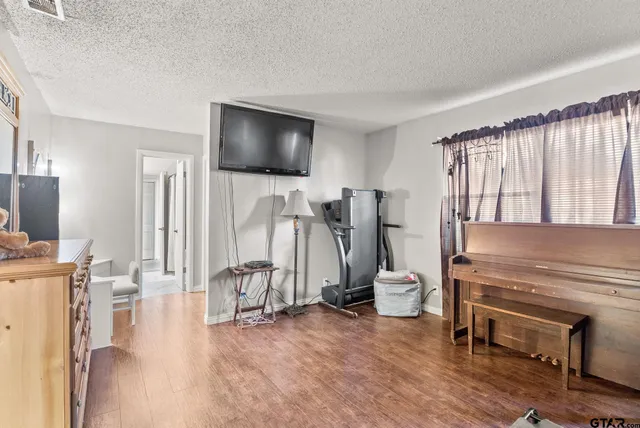 a view of a dining room with furniture a chandelier and wooden floor