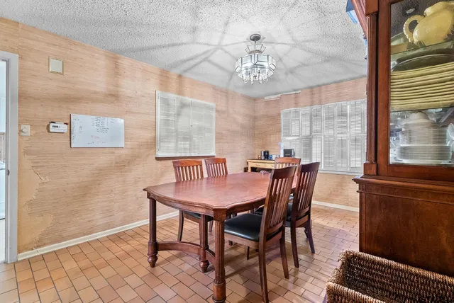 a view of a dining room with furniture and a chandelier