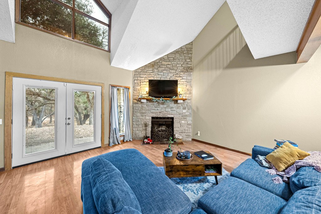 805-119 Highway 534 Loop Kerrville, TX 78028 - Photo 6 of 23 a living room with furniture a flat screen tv and a fireplace