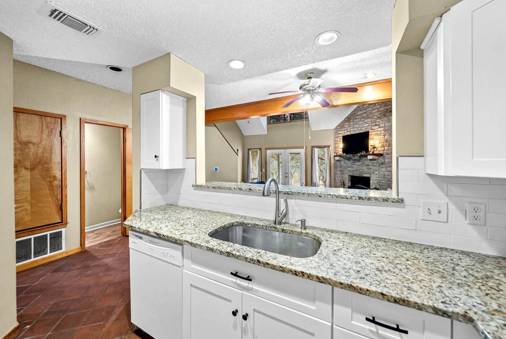 805-119 Highway 534 Loop Kerrville, TX 78028 - Photo 9 of 23 a kitchen with stainless steel appliances granite countertop a sink and white cabinets