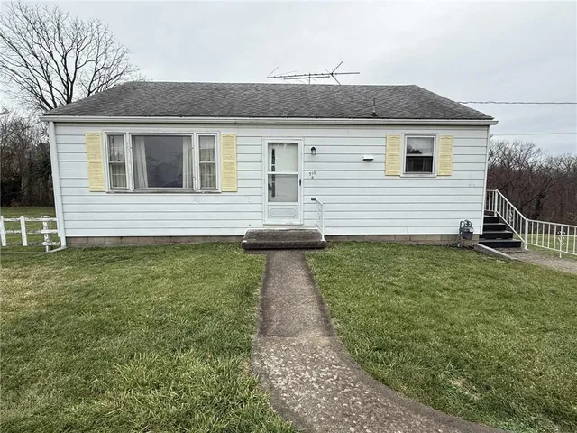 a front view of a house with a yard