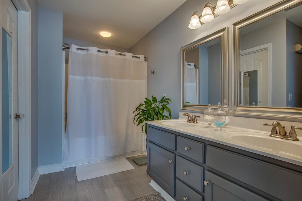 14082 Mt Pleasant Road Rockvale, TN 37153 - Photo 17 of 30 a bathroom with a granite countertop sink a mirror and a shower