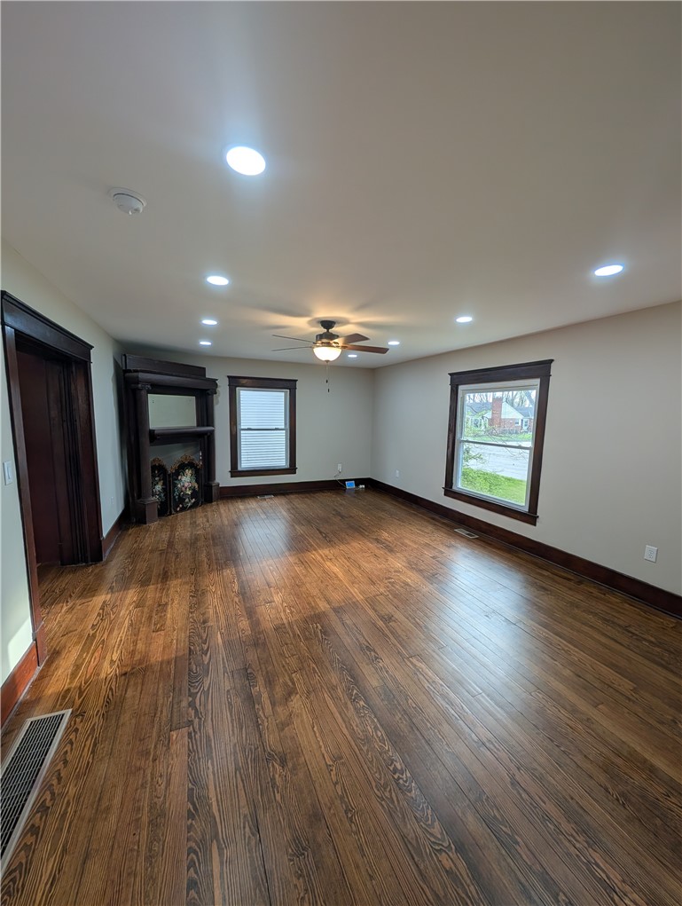 10796 Preble County Line Road Brookville, OH 45309 - Photo 6 of 33 This living area features gleaming hardwood floors and ample natural light, creating an inviting atmosphere.