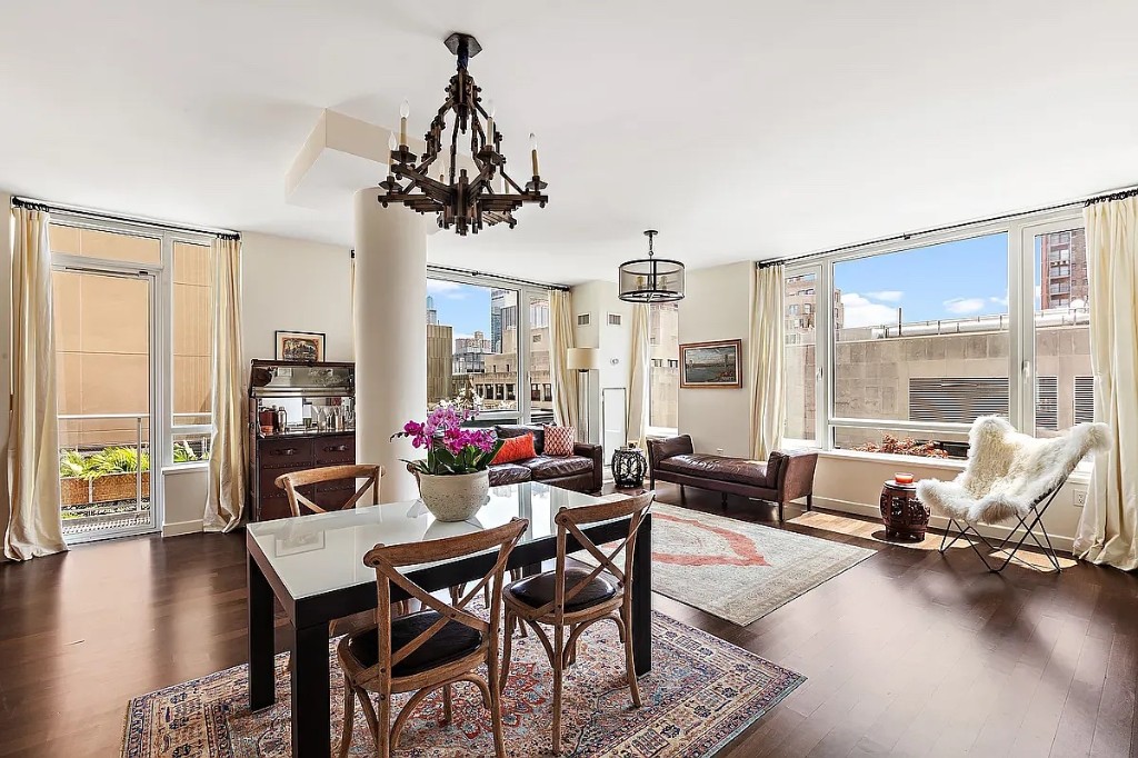 261 West 28th Street, Unit 10D Manhattan, NY 10001 - Photo 6 of 19 a view of a dining room with furniture window and wooden floor