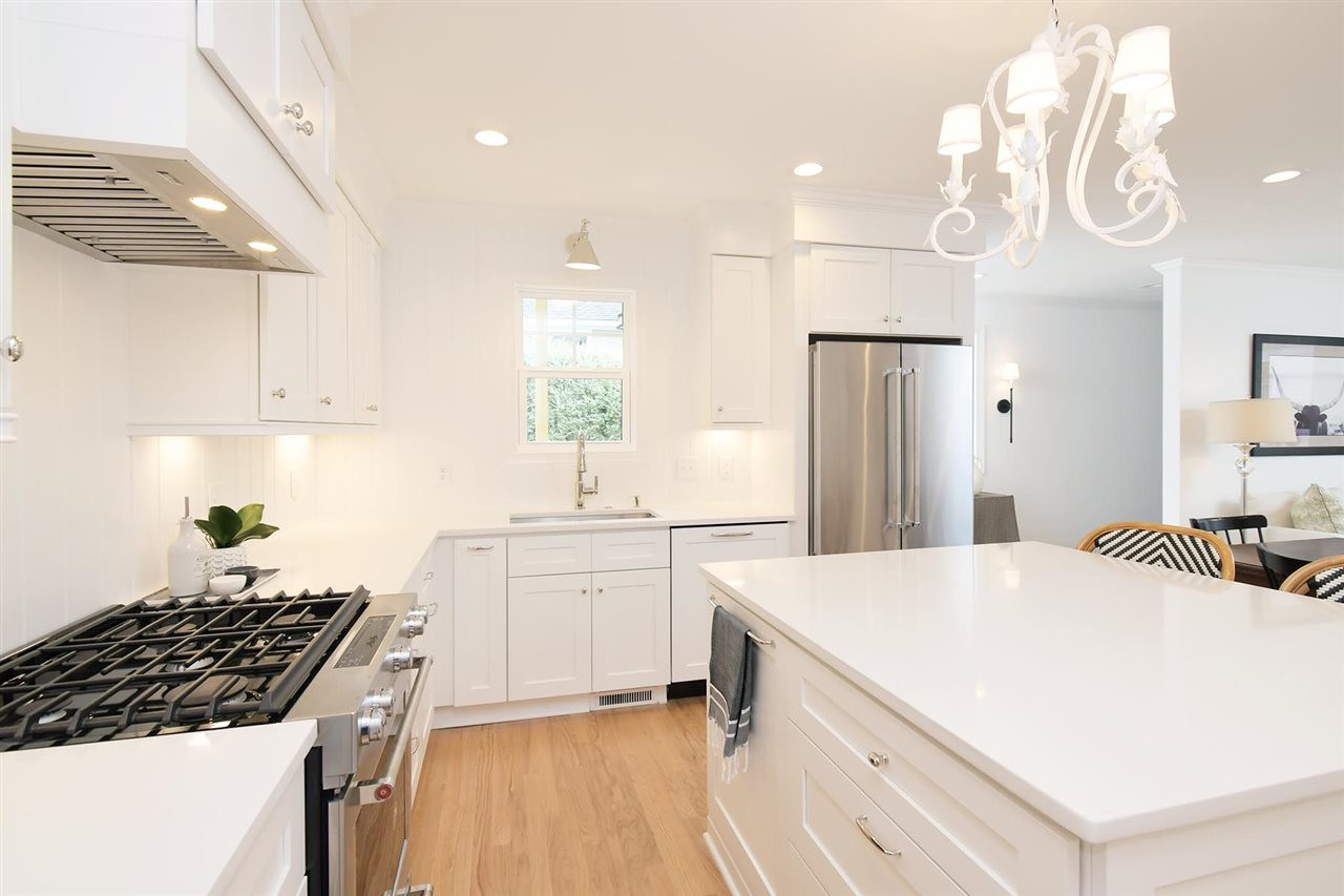 2017 Pine Drive Raleigh, NC 27608 - Photo 7 of 25 a kitchen with granite countertop a sink a stove refrigerator and cabinets