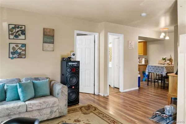a living room with furniture and wooden floor