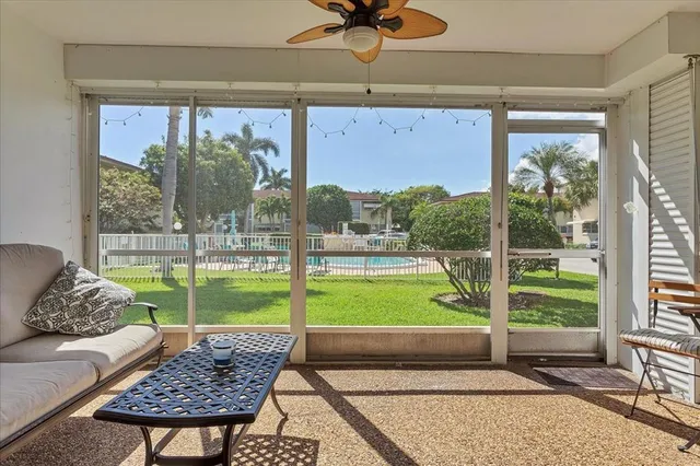 a living room with a large window and a table
