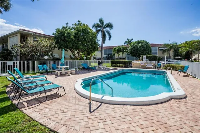 a view of a swimming pool with lounge chair