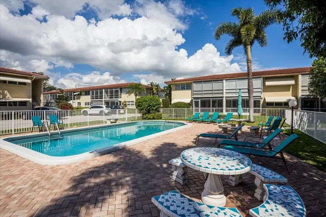 a view of a patio with couches potted plants and a patio