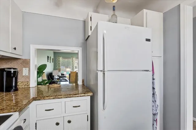 a white refrigerator freezer sitting inside of a kitchen