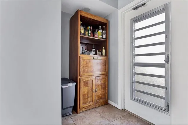 a kitchen with a refrigerator and window
