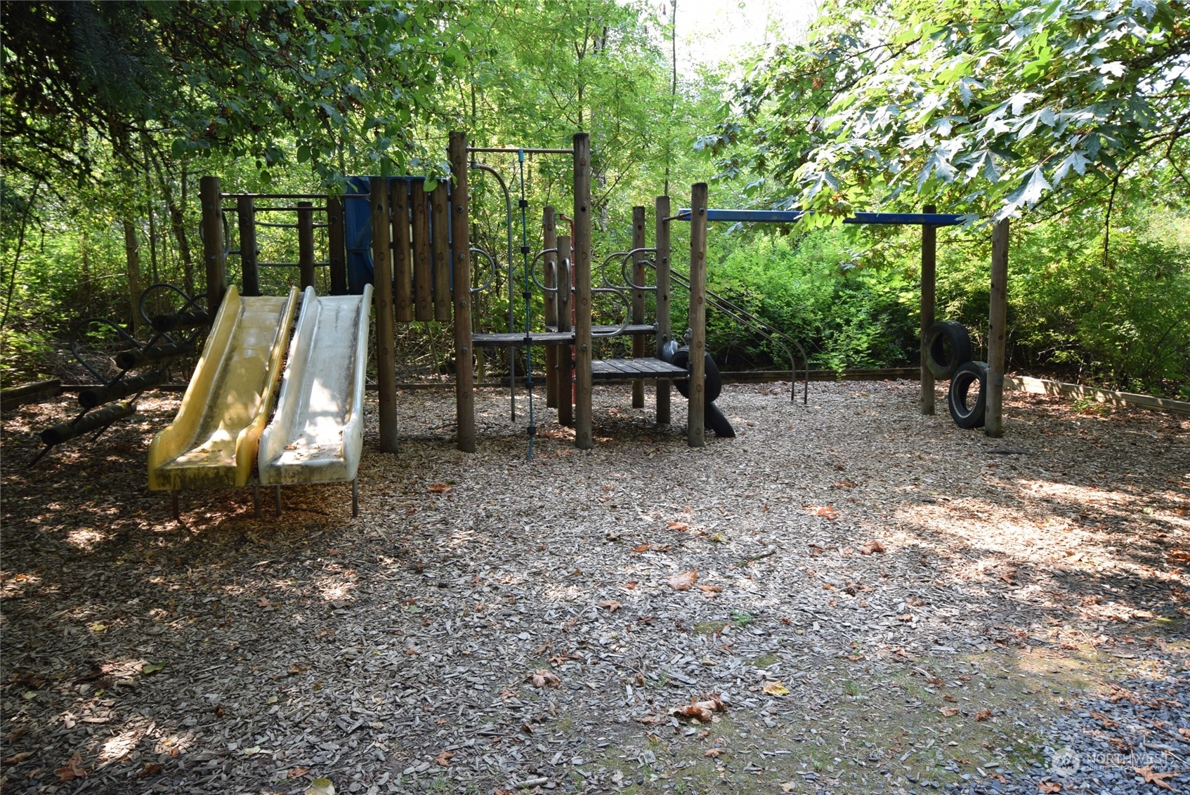 22424 15th Place West Bothell, WA 98021 - Photo 1 of 1 a view of a park with large trees and wooden fence