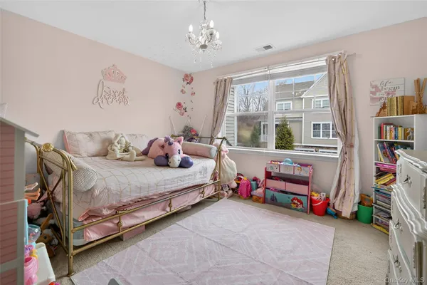 a bedroom with a bed and a book shelf