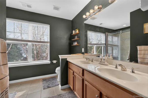 a bathroom with a sink double vanity and a mirror
