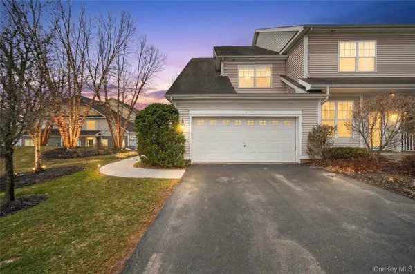 a view of a house with a yard and garage