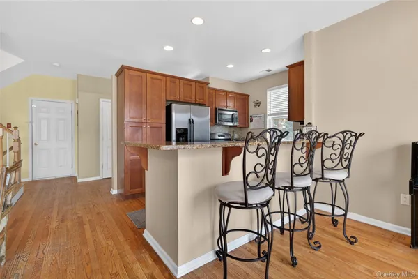 a view of a dining room with furniture kitchen and wooden floor