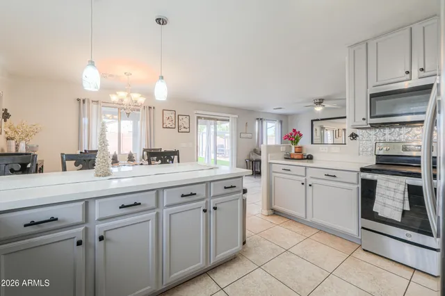 a living room with furniture a window and a chandelier