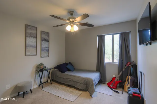 a view of a patio with table and chairs potted plants with floor to ceiling window