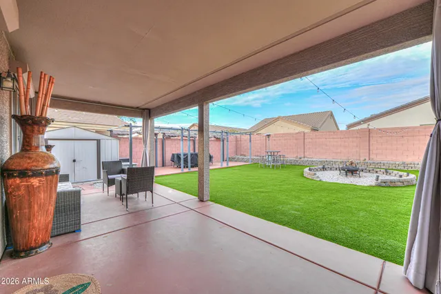 a view of a house with backyard porch and sitting area