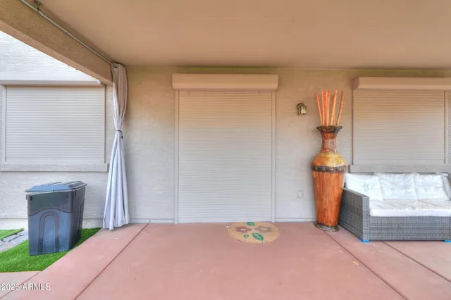 a view of a patio with a table chairs and garden