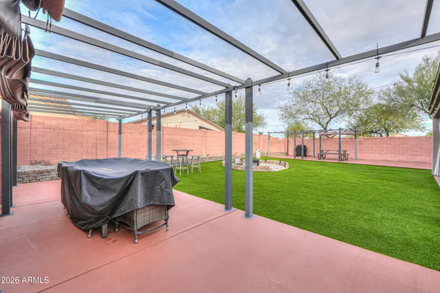a view of a porch with a table and chairs