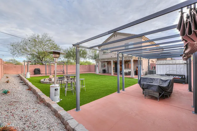 a view of a yard with a table and chairs
