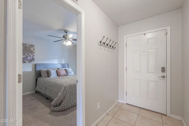 a bedroom with a bed and a ceiling fan