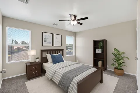 a bedroom with a large bed and a chandelier