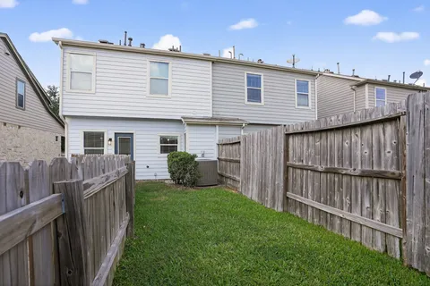 a view of a house with backyard and porch