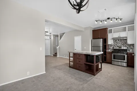 a view of workspace and kitchen with fireplace