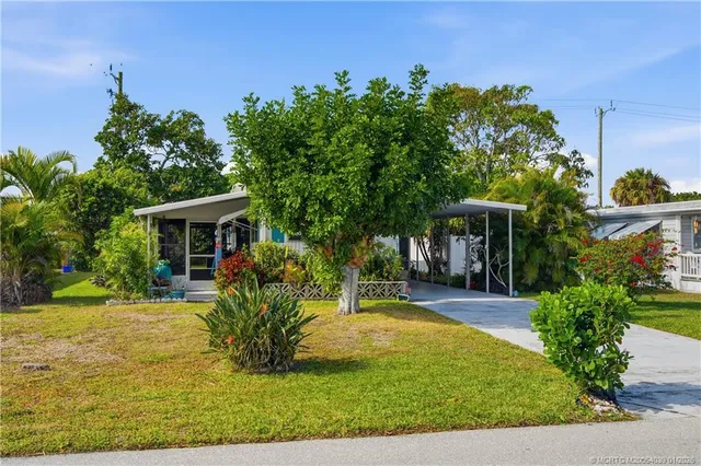 a view of a house with backyard porch and sitting area