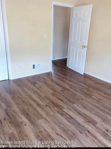 an empty room with wooden floor