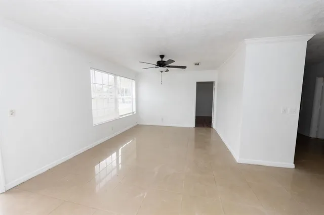 an empty room with windows and closet