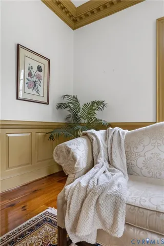 a bed sitting in a bedroom next to a window with rug