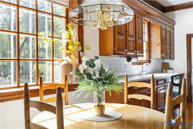 a vase of flowers sitting on a table with a window