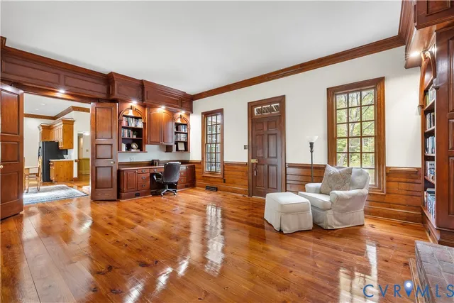 a living room with furniture and large windows