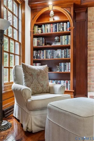 a living room with furniture a bookshelf and a book shelf