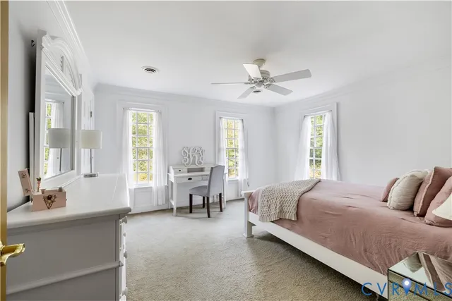 a spacious bedroom with a bed and a chandelier
