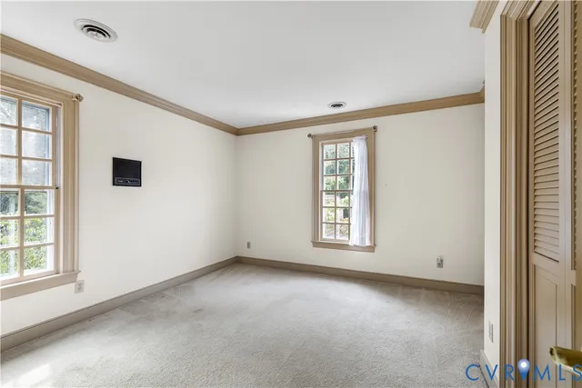 an empty room with windows and closet