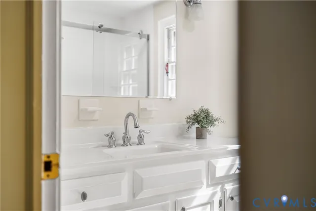 a bathroom with a sink a mirror and a shower