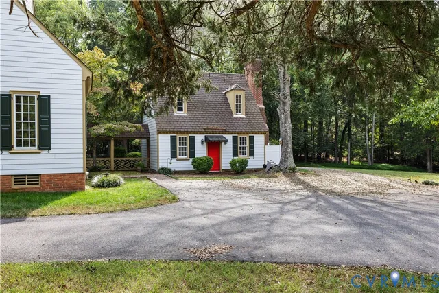 a front view of a house with yard and green space